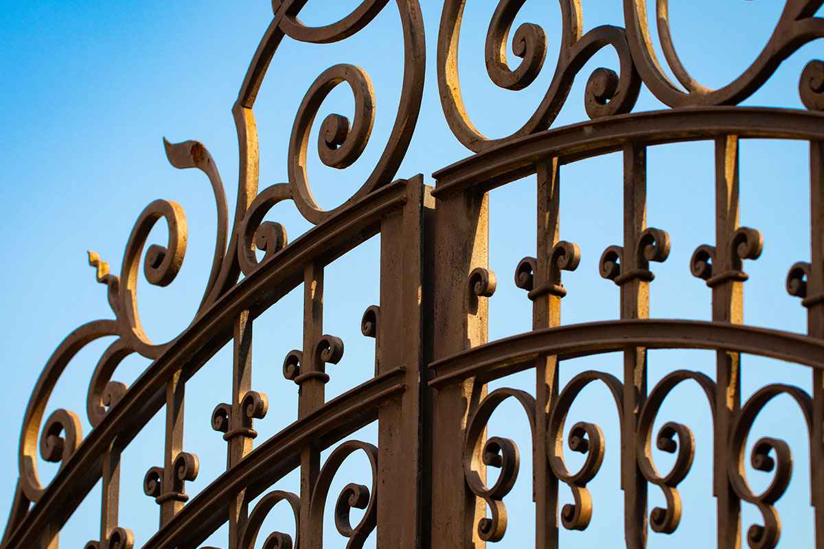 iron fence with blue sky behind it in Los Angeles.